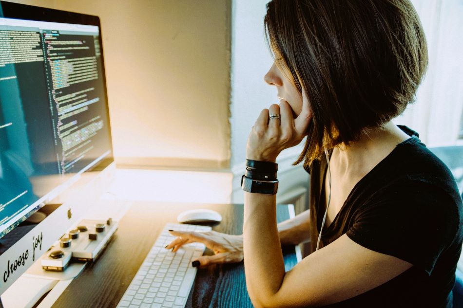 Woman analyzing her finances, an important behavior in holistic financial well-being achieved through financial behavior change.