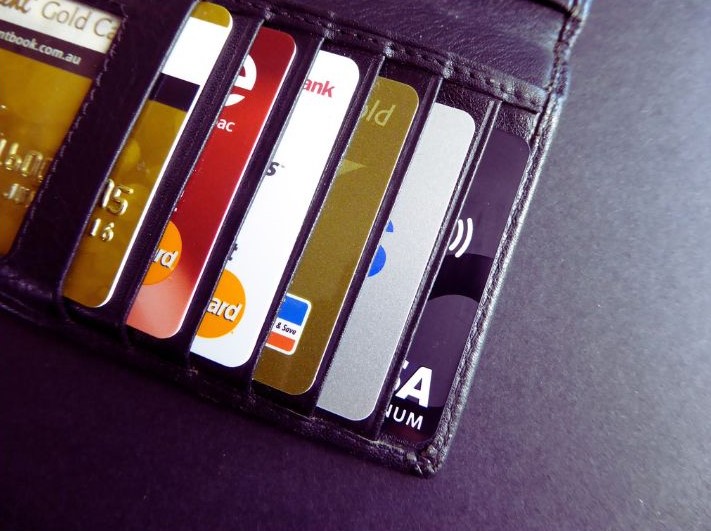 Image shows wallet with credit cards. Reducing credit card debt is an example of holistic financial well-being gained through financial behavior change